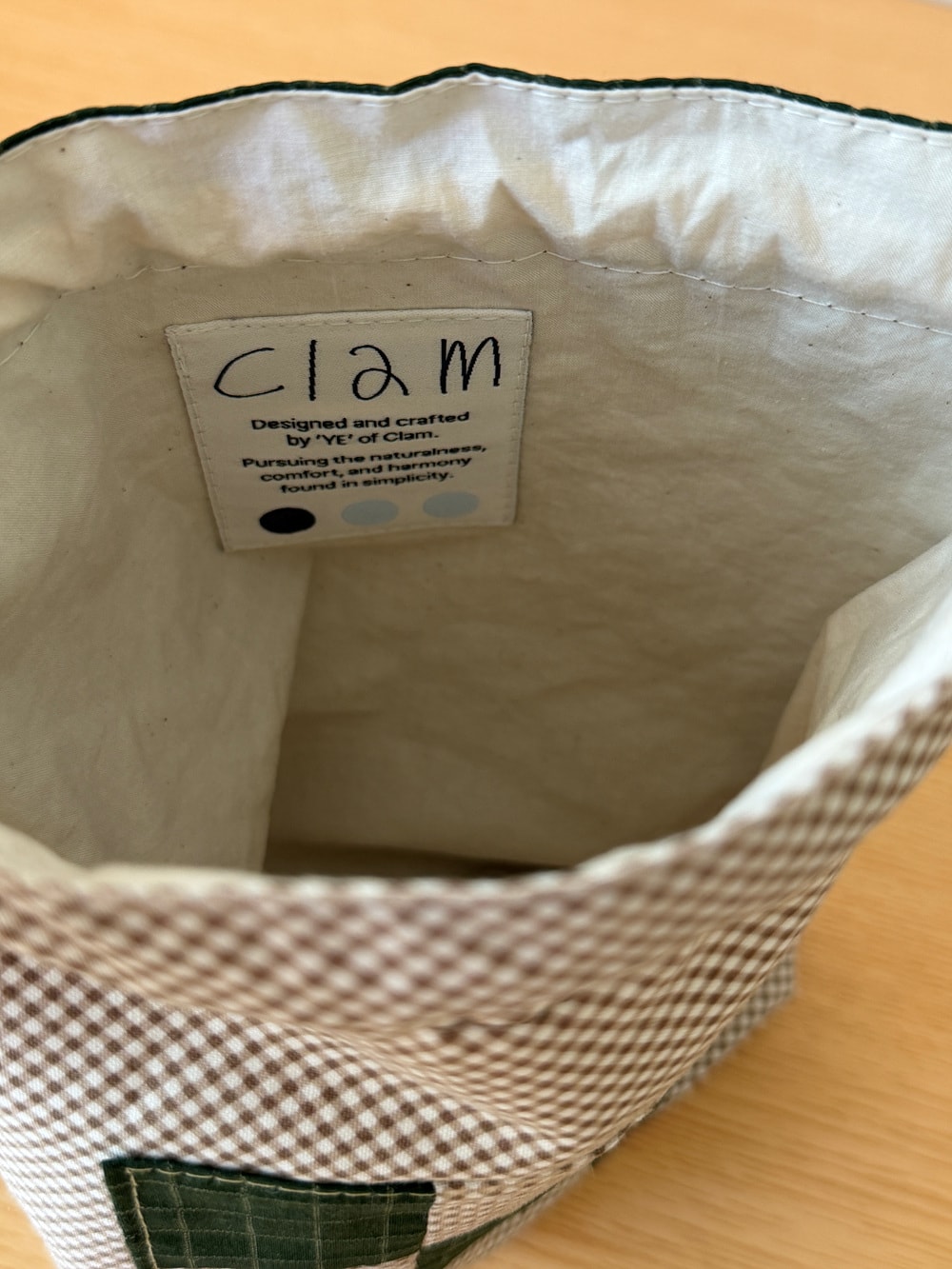 [공식몰 한정] Piece by piece String pouch Check Green